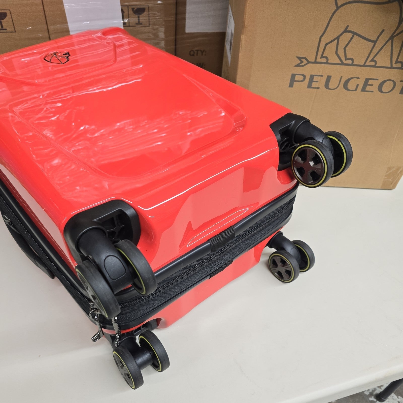 Orange PEUGEOT FRANCE  RED PEUGEUT Zip International Carry-On Spinner